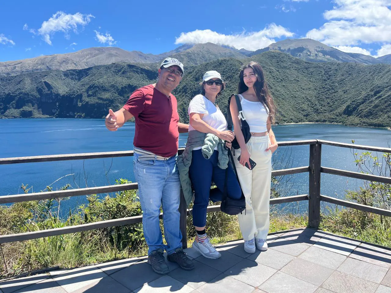 Tourists enjoying the view of Cuicocha Lagoon in Ecuador